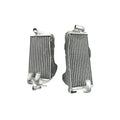 Two silver metal radiators on a white background