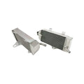 Two metallic radiators on a white background