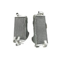 Two silver metal radiators on a white background