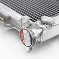 Close-up of a radiator with a warning label on a white background
