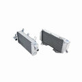 Two metallic radiators on a white background