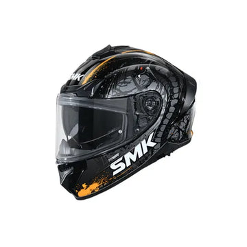 Black motorcycle helmet with clear visor and 'SMK' branding on a white background